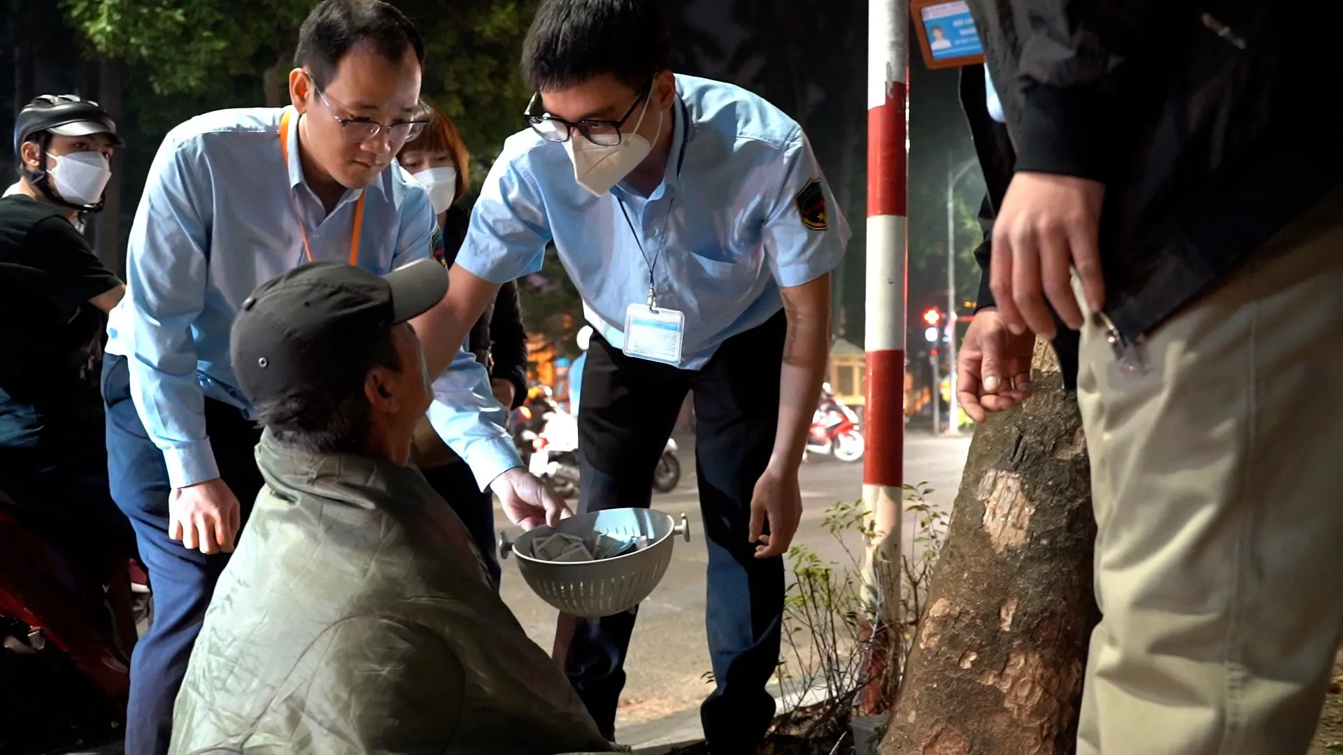 Cán bộ, nhân viên Đội Trật tự xã hội lưu động tiếp cận và tập trung đối tượng người lang thang xin tiền về Trung tâm Công tác xã hội và Quỹ Bảo trợ trẻ em Hà Nội. Ảnh: Trần Oanh